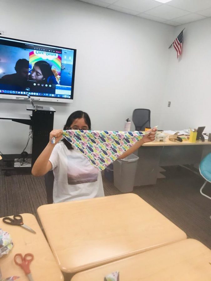 student folding scarves