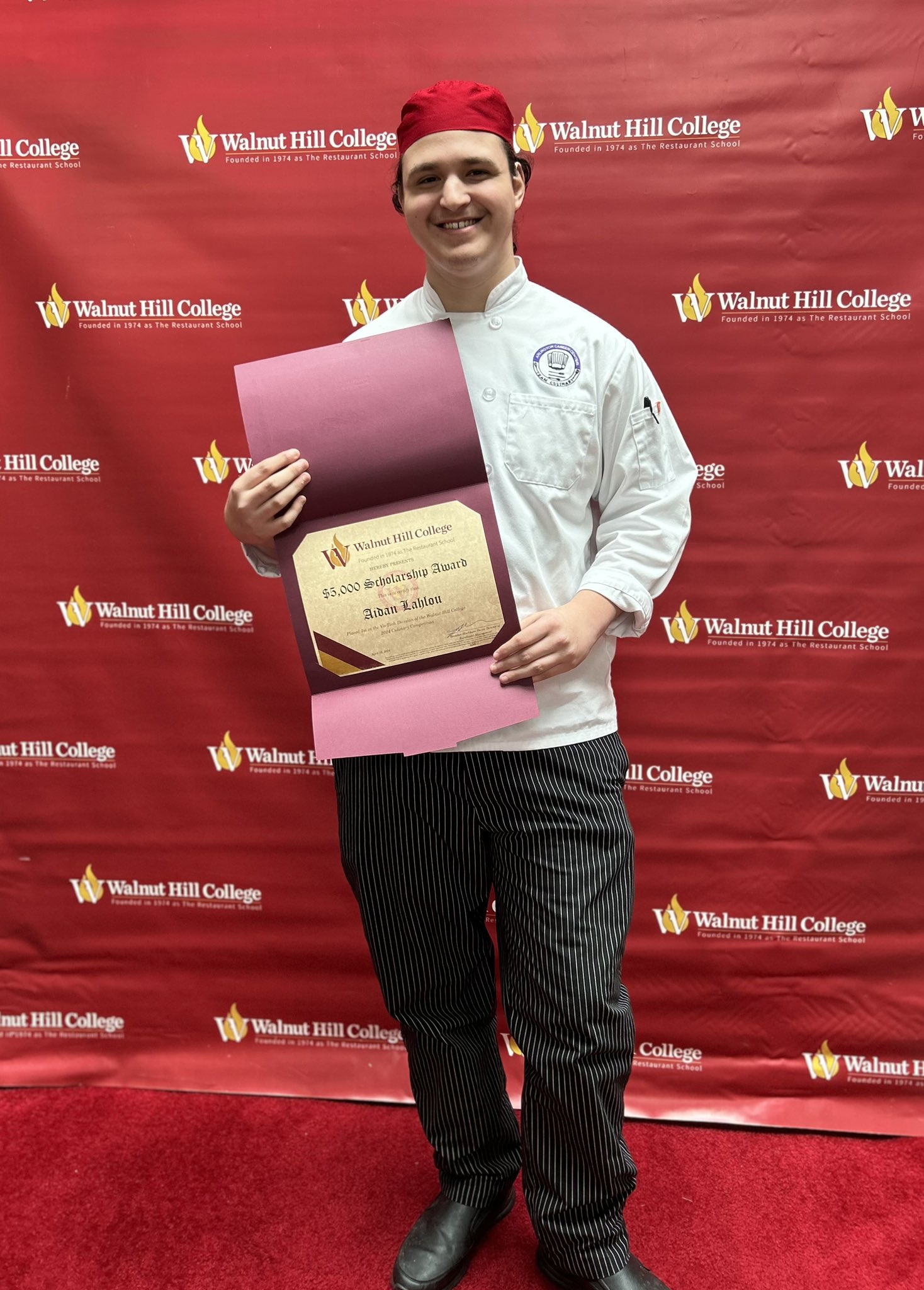 Picture of Aidan posing with his 1st place scholarship certificate at the Walnut Hill College Culinary Competition