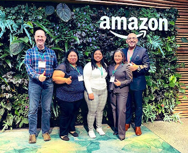 ACC and Amazon representative in front of an Amazon sign