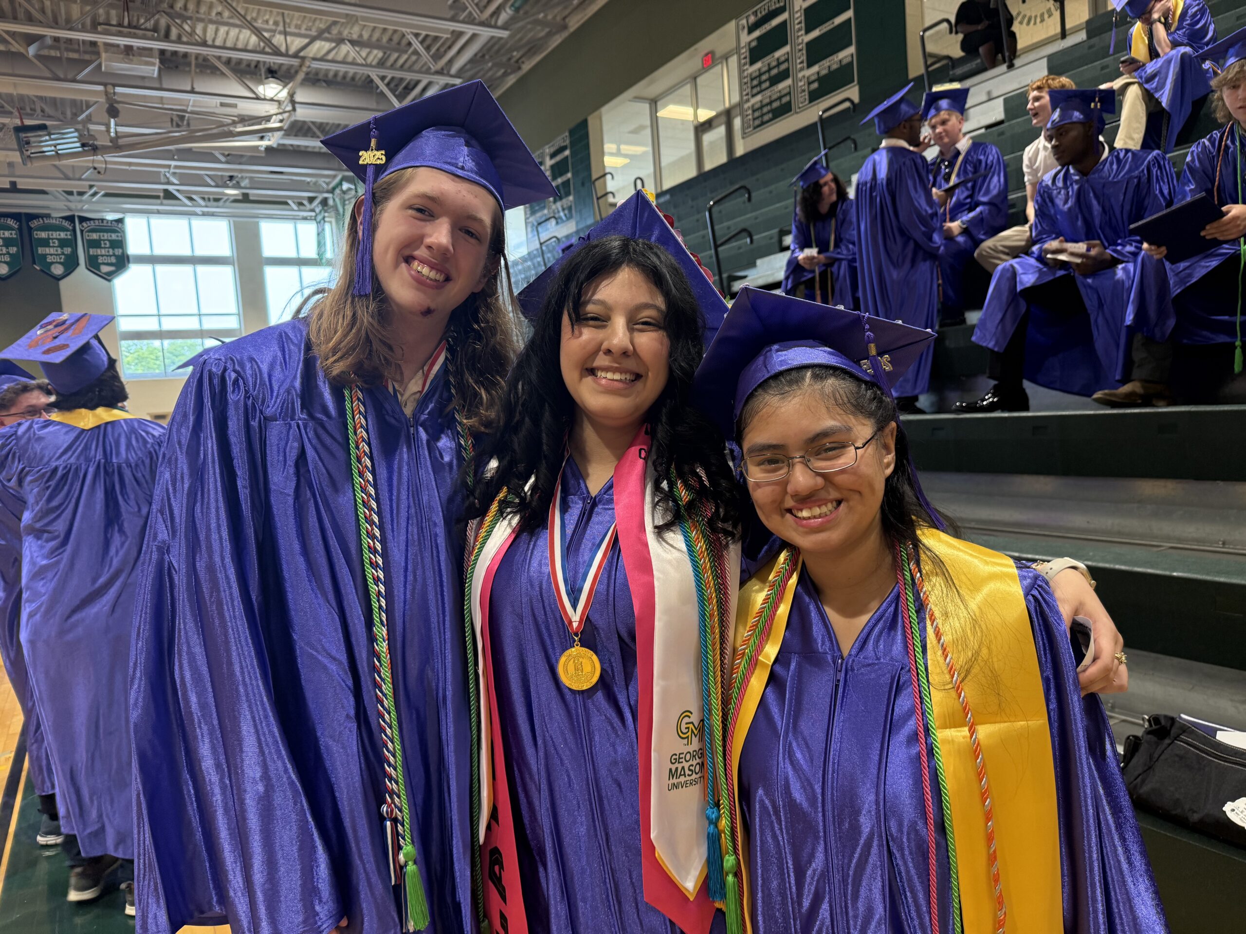 Picture of three students in the class of 2025 on graduation day