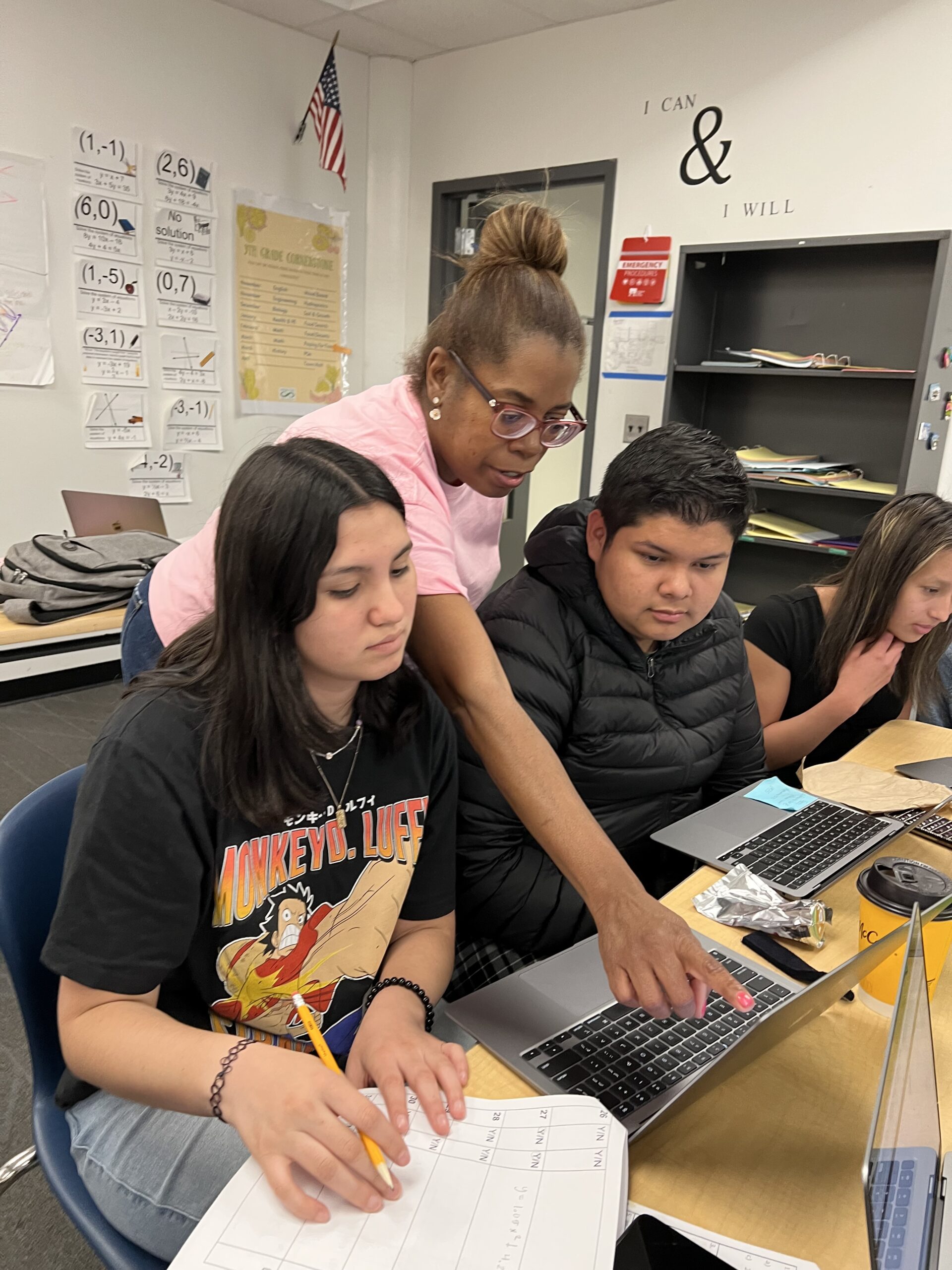 Señora Odalys supports two students with their project