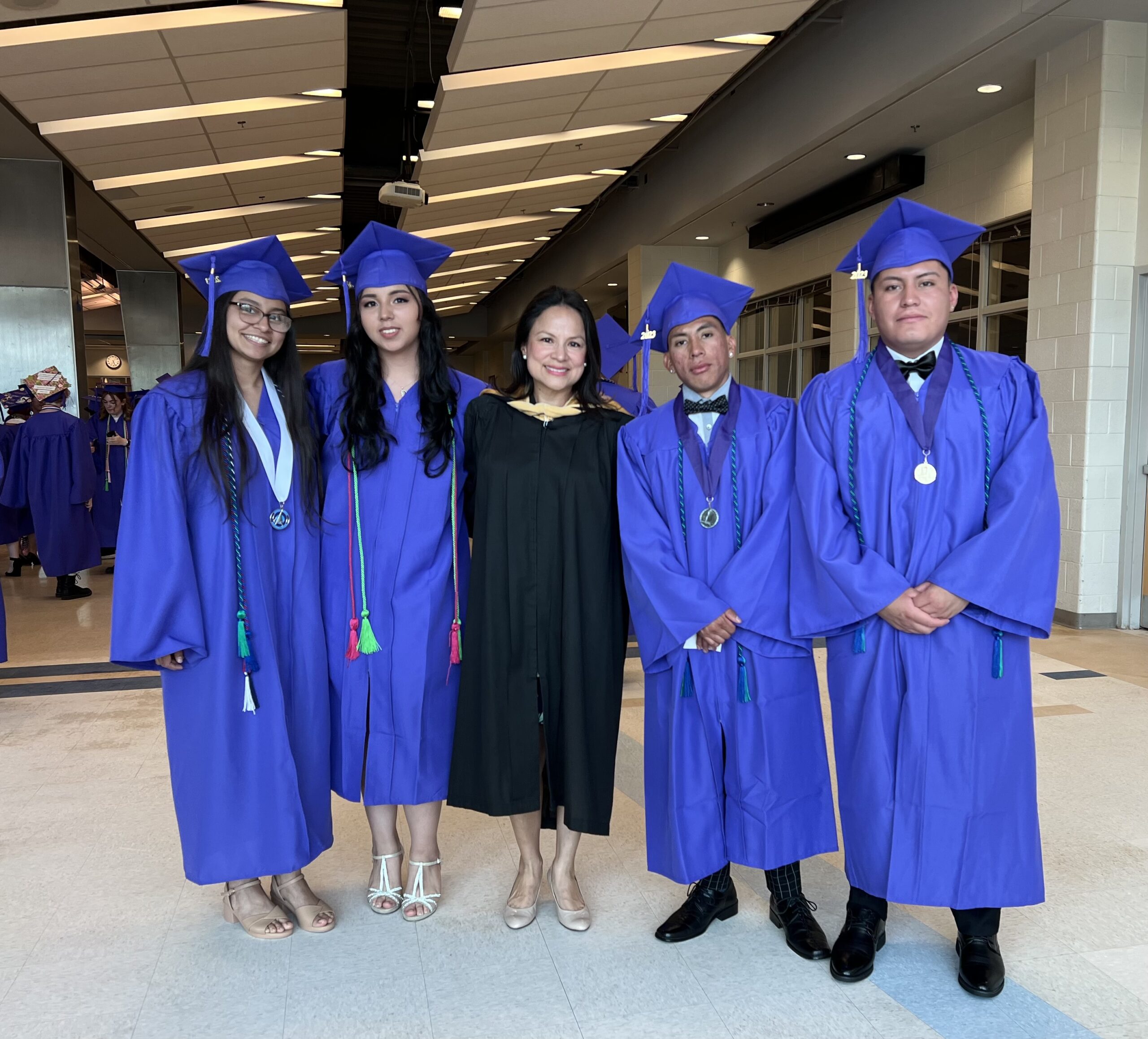 ELI students pose with Principal Margaret Chung during the 2025 commencement ceremony